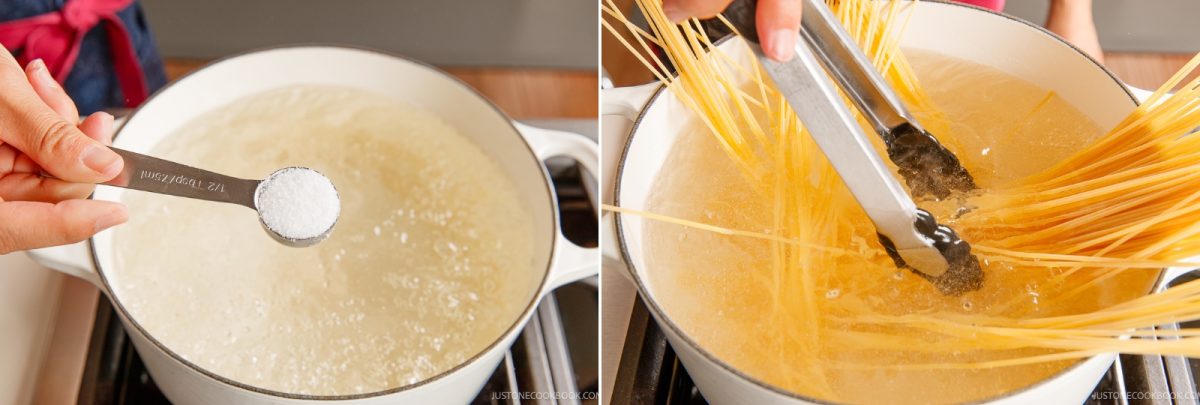 A hand adds a spoonful of salt to boiling water in a pot, followed by a hand using tongs to submerge long noodles for a Napolitan pasta dish.