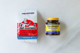A package of Saf-Instant dry yeast and a jar of Fleischmann&rsquo;s Bread Machine yeast sit side by side on a light-colored surface.