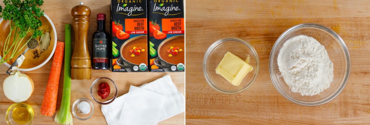 A wooden surface displays various ingredients: parsley, carrot, celery, onion, olive oil, salt, pepper grinder, red wine, beef broth cartons, paprika, butter, and flour in bowls, prepared for a demi-glace recipe.