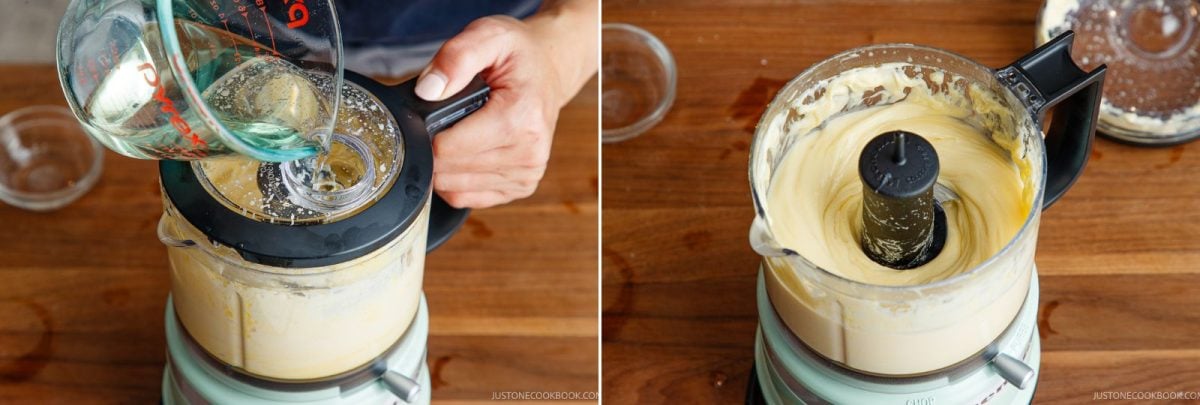 A person pours oil into a running food processor filled with mayo. Next to it, the blended, smooth mixture in the same food processor is shown from above on a wooden surface.