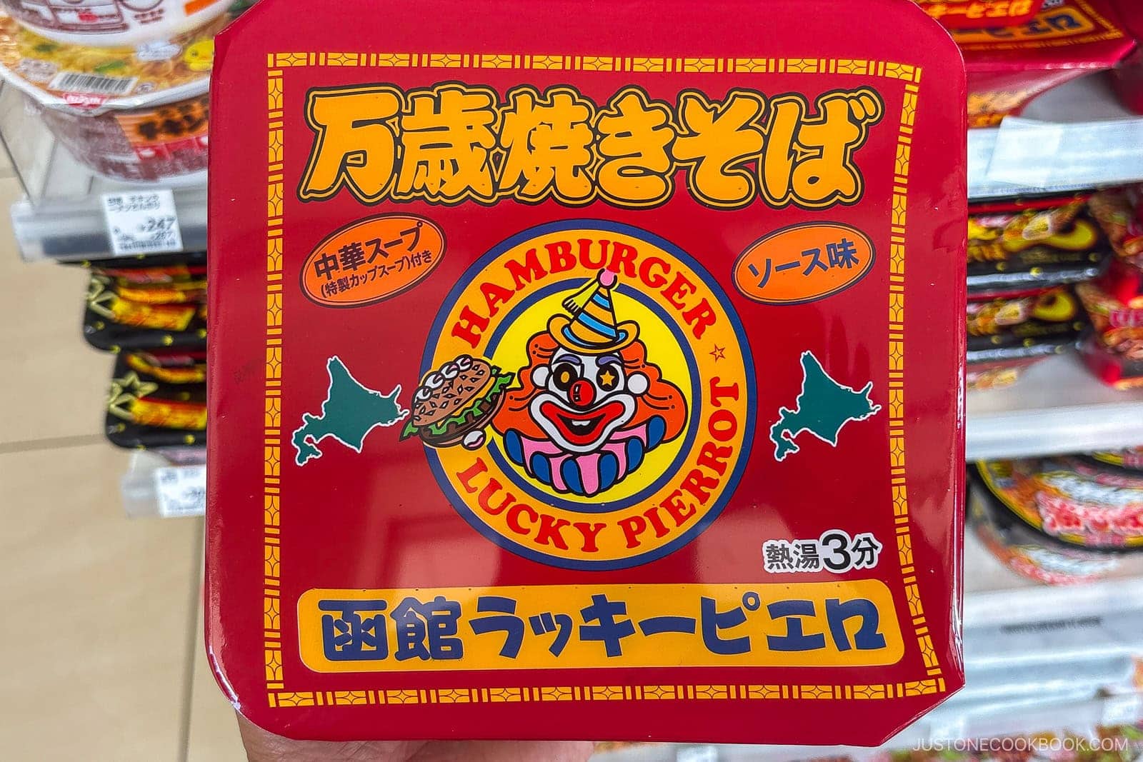 A red instant noodle package labeled Hamburger Lucky Pierrot, considered by some as the best instant ramen in Japan, features a clown holding a hamburger, Japanese text, and preparation instructions.