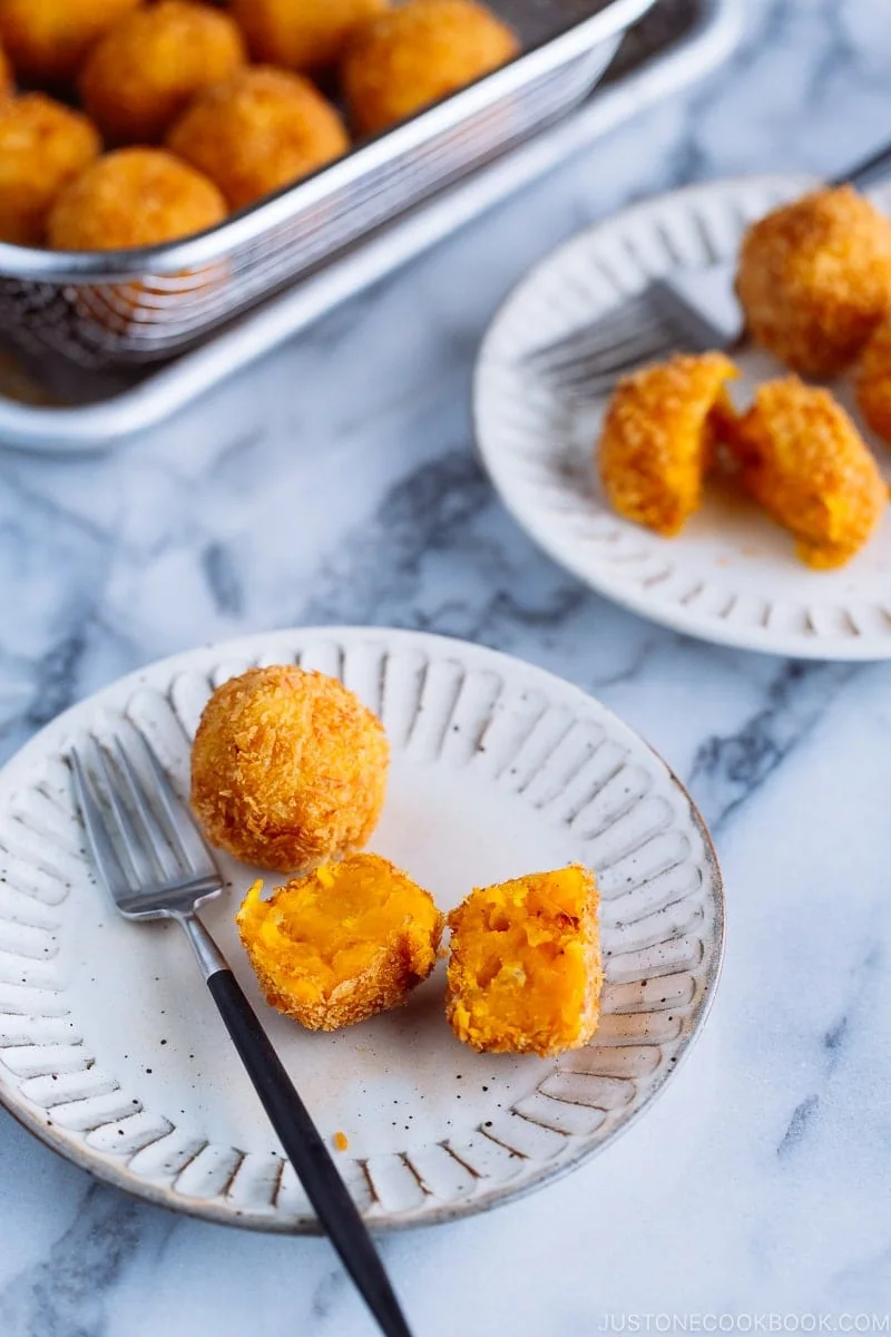 Ceramic plates containing round Kabocha Croquettes (Korokke).