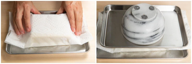 Two images: on the left, hands pressing tofu between paper towels on a tray; on the right, a heavy object placed on the wrapped tofu to press out water&mdash;a key step when preparing dishes like ganmodoki.