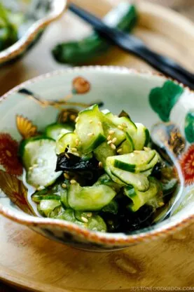 Small Japanese bowls containing Japanese cucumber salad called Sunomono.
