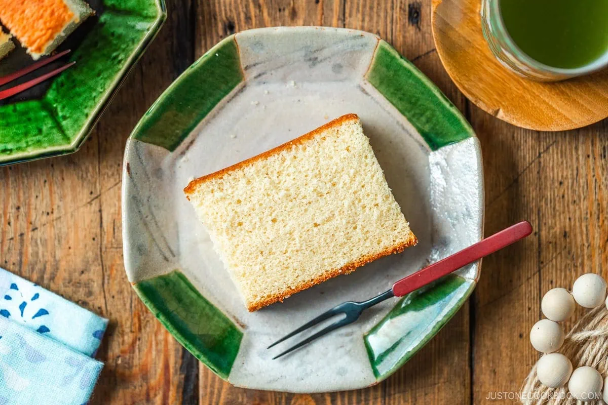 An octagon plate containing a slice of Castella cake.