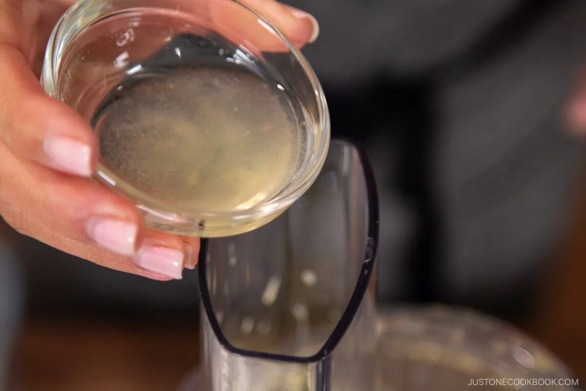 Add the rice vinegar, lemon juice, and remaining oil. Process for an extra 10 seconds,&nbsp;just&nbsp;until the ingredients are combined and emulsified.