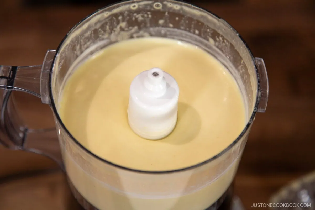 Add the rice vinegar, lemon juice, and remaining oil. Process for an extra 10 seconds,&nbsp;just&nbsp;until the ingredients are combined and emulsified.