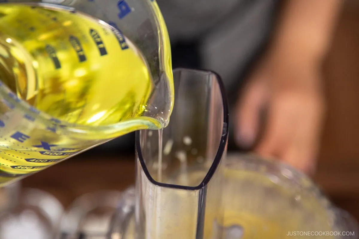 With the food processor running on the Stir setting,&nbsp;SLOWLY&nbsp;add about&nbsp;one-third of the&nbsp;neutral oil&nbsp;in a thin, steady stream. The mixture will begin to thicken and emulsify.